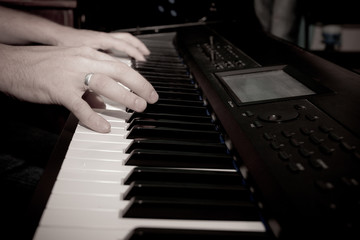 Fototapeta na wymiar Close-up of hand playing the piano