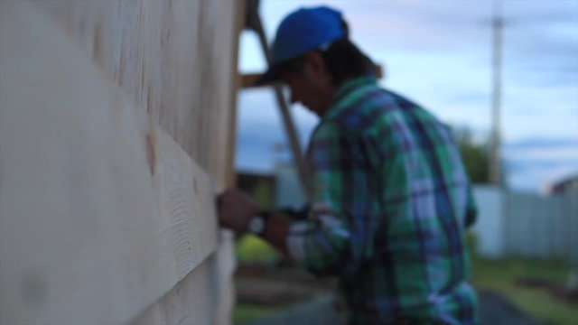 Good Job/Carpenter fixing Wood Siding on the House
