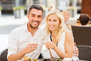 happy couple clinking glasses at restaurant lounge