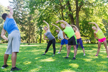group of friends or sportsmen exercising outdoors