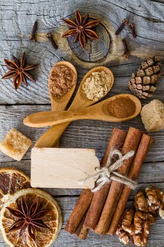 Selection of christmas spices on rustic wood background