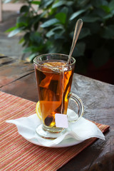 Cup with tea and a lemon , effect bokeah