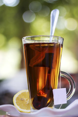 Cup with tea and a lemon , effect bokeah