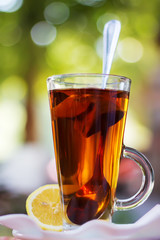Cup with tea and a lemon , effect bokeah
