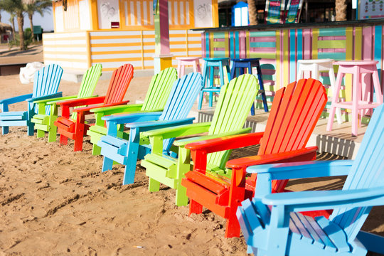 Colorful Wooden Chairs On Beach