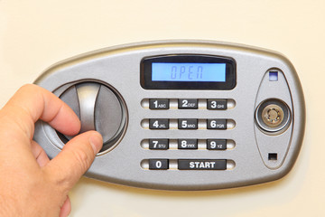 Man hand open of electronic home safe.