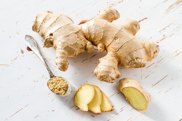 Ginger root on white wood background