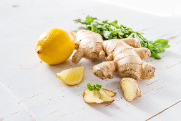 Ginger lemon mint on white wood background