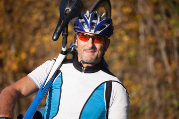 cyclist - man carries bicycle