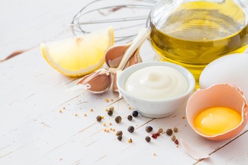 Mayonaise ingredients on white wood backgound