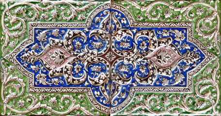 Embossed colorful Old Persian Tile in Green and Blue Colors with Islamic Motif Design.