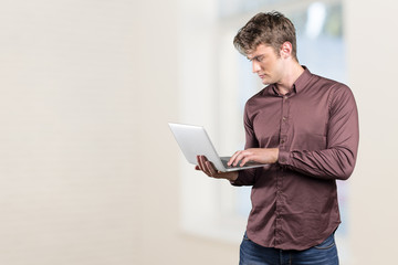 Young man holding laptop