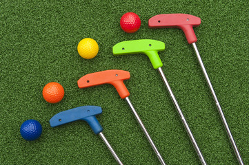 Four Mini Golf Putters and Balls