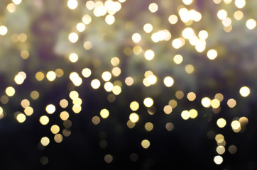 yellow and gold Bokeh Light and gradient shade to black color in Christmas Festival Central...