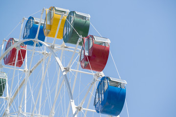 Colorful ferris wheel with blue sky