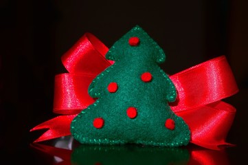 A toy of Christmas tree with a red bow