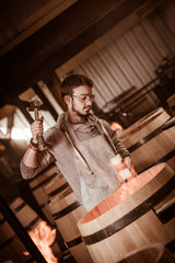 Fototapeta na wymiar Worker in Barrel Making in Bordeaux Wineyard