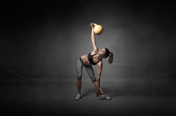 girl looking a kettlebell