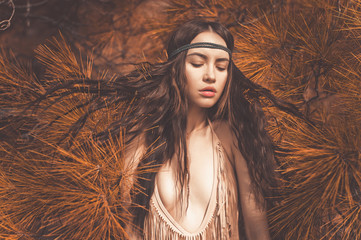 Beautiful lady hippie in fir forest