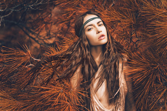Beautiful lady hippie in fir forest