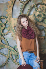 Naklejka premium Beautiful curly-haired girl in hat and jeans