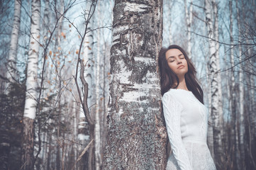 Beautiful lady in a birch forest