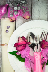Holiday romantic table setting with pink roses on a white background