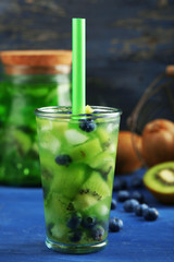 Kiwi and Blueberry cocktail on wooden background