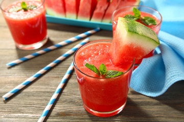 Glasses of watermelon juice on wooden table, closeup