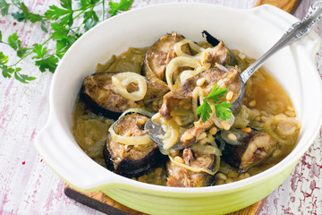 Grilled mackerel fish baked with onions and pine nuts