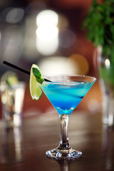 Glasses of cocktails on bar background