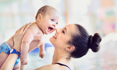 Attractive mother carrying  her cute child