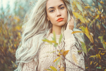 Beautiful lady surrounded autumn leaves
