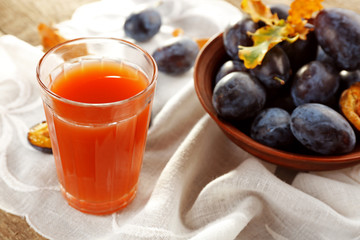 Plum Juice in a glass with fresh fruits