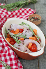 carp steak with rosemary and pepper in a ceramic form