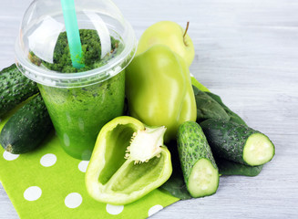 Fresh vegetable juice on color wooden background
