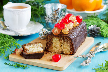 Fototapeta na wymiar Chocolate cake with candied fruit for Christmas.