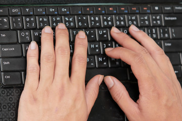 Typing on keyboard.