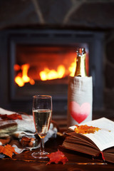 Bottle of wine on table, on fireplace background