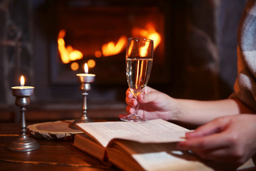 Bottle of wine on table, on fireplace background