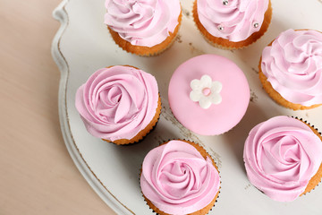 Tasty cupcakes on stand, close-up