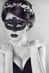 Beautiful Girl in black veil mask. Masquerade. Makeup. Hairstyle
