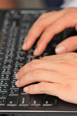 Close-up of typing male hands