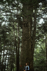 Fototapeta premium beautiful happy cute stylish girl near a big tree in the mountai