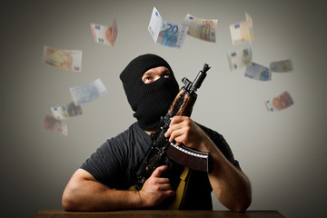 Man with gun and euro banknotes.