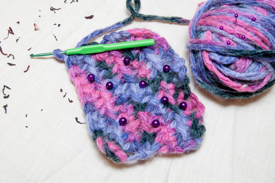 multicolor ball of yarn and knitting