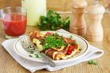 Breakfast omelet with tomatoes.
