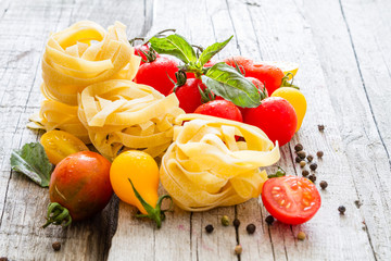 Raw pasta, tomato, basil
