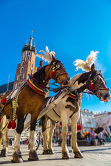 Fototapeta na wymiar Horse carriages at main square in Krakow