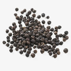 Close up of whole black peppercorns against a white background